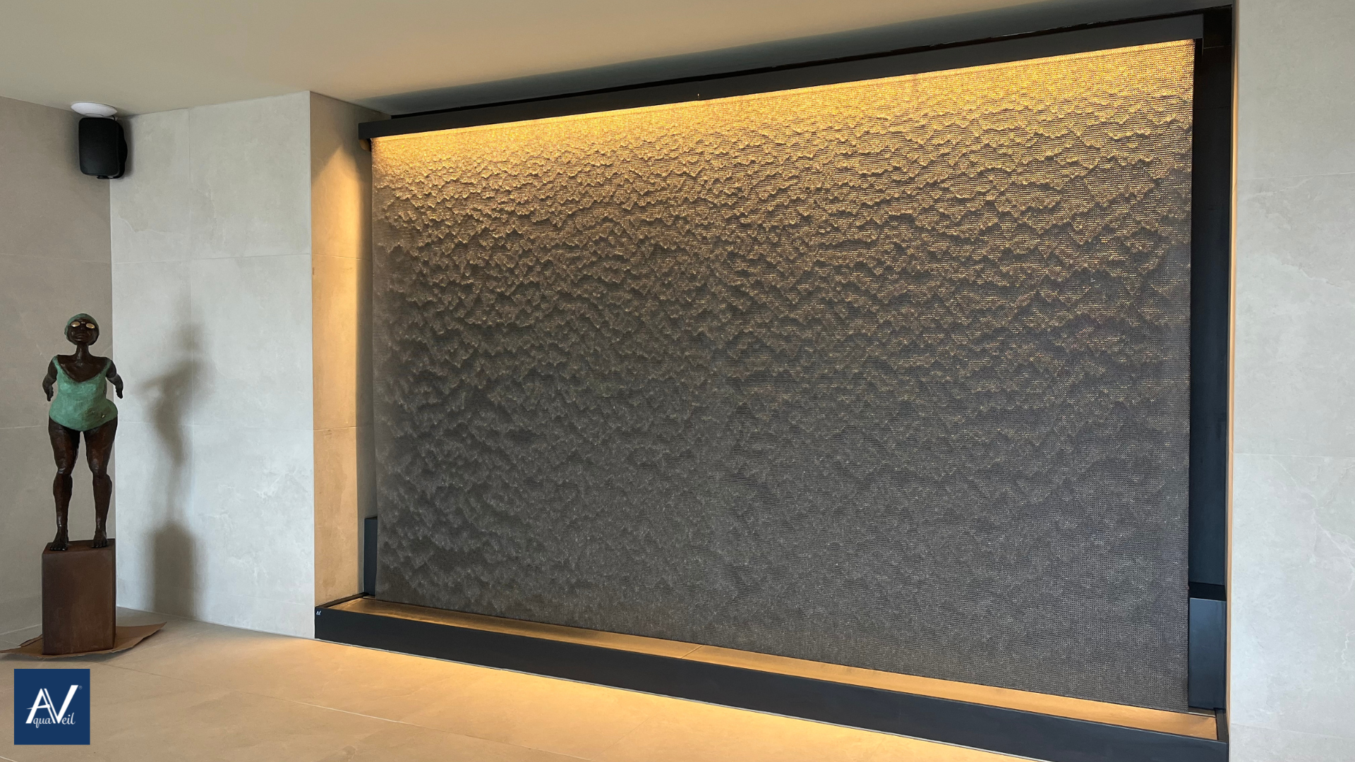 indoor swimming pool water wall as a water fall in an alcove in the pool building wall